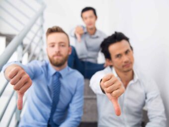Group of multiethnic men showing thumb down