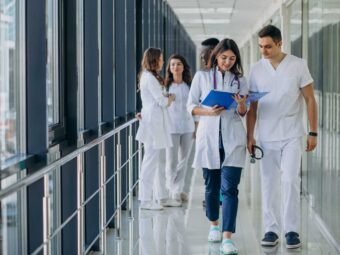 team-young-specialist-doctors-standing-corridor-hospital