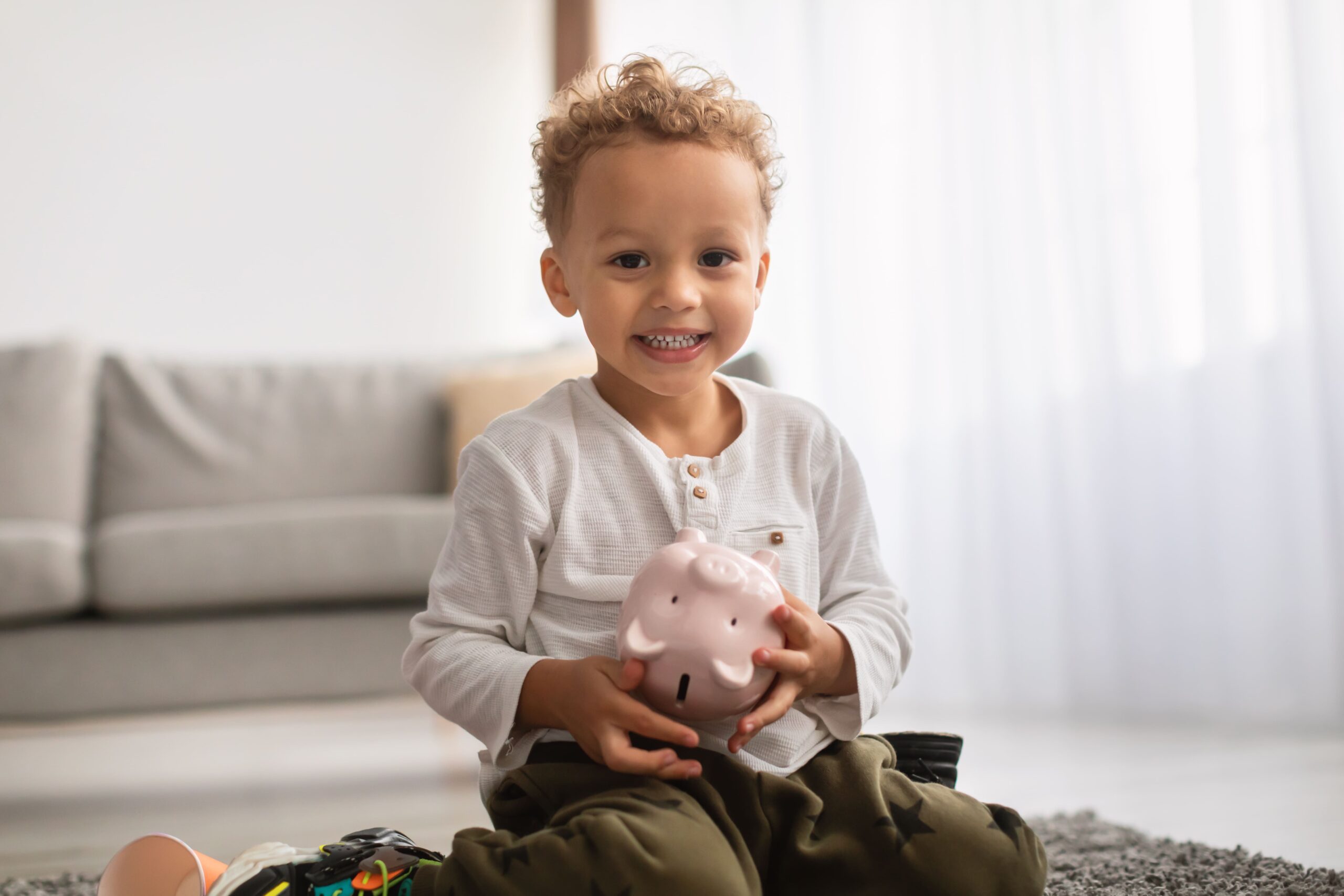 happy-black-little-boy-posing-holding-piggybank-si-2025-03-18-18-56-38-utc (1)