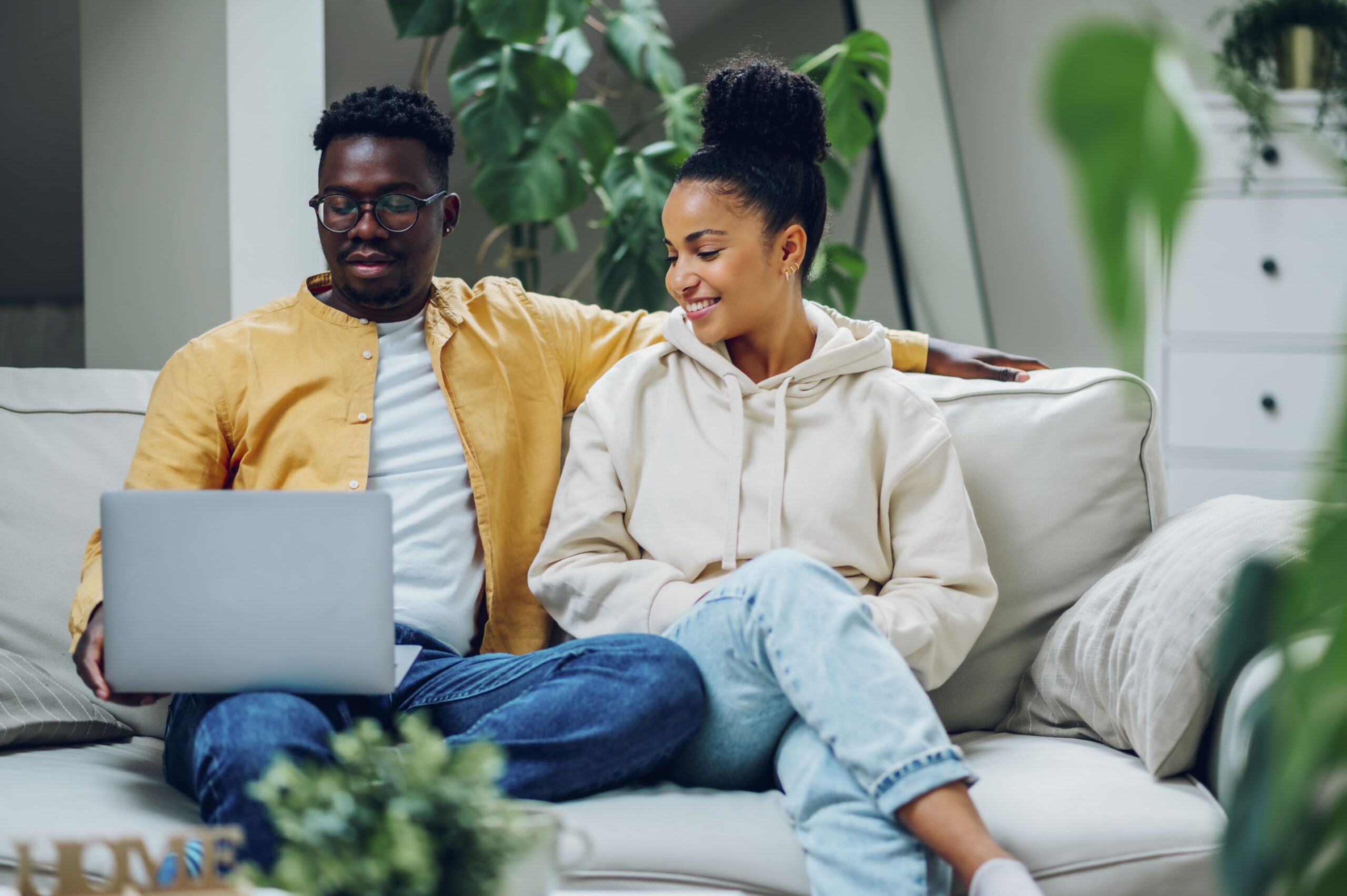 multiracial-couple-using-laptop-while-sitting-on-a-2025-04-02-01-12-50-utc (1)