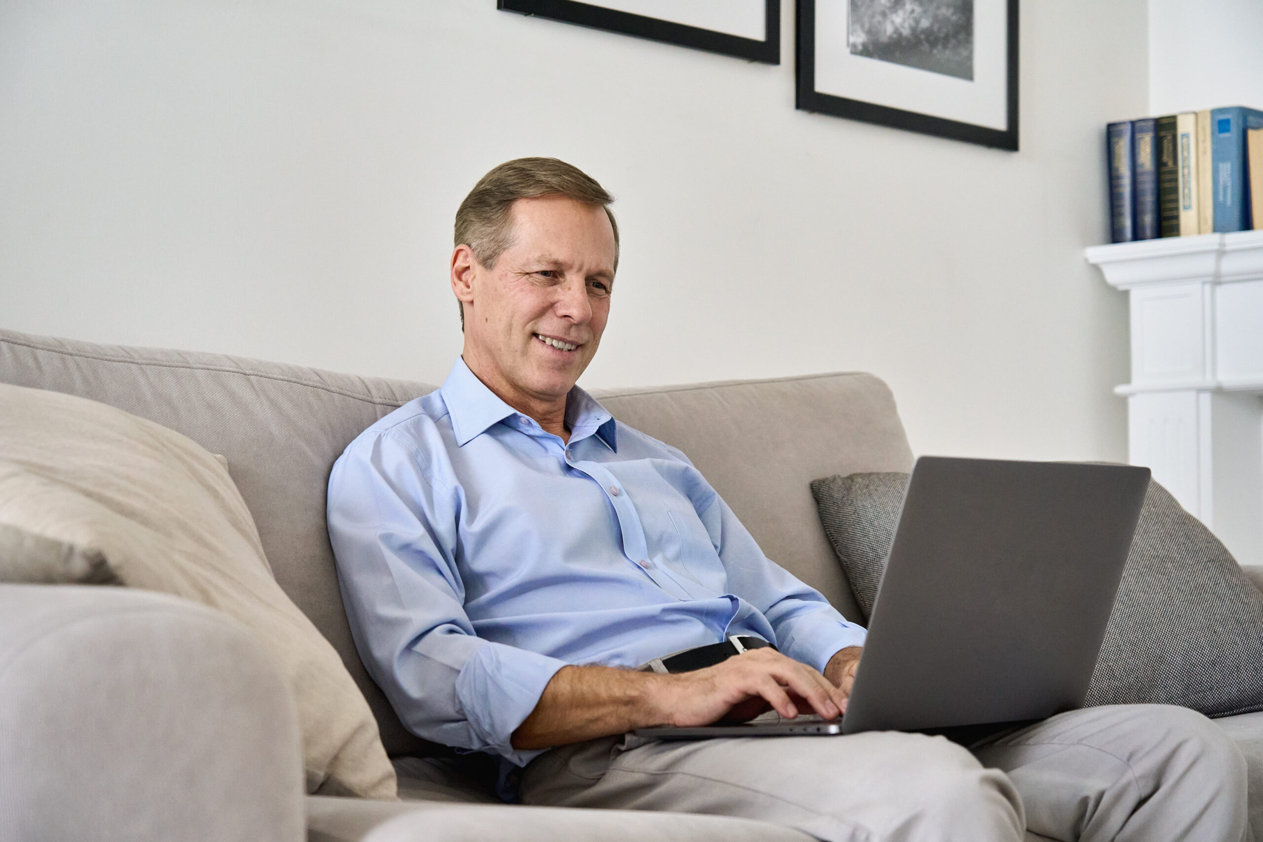 smiling-middle-aged-man-using-laptop-computer-sitt-2025-02-11-16-17-29-utc (1)